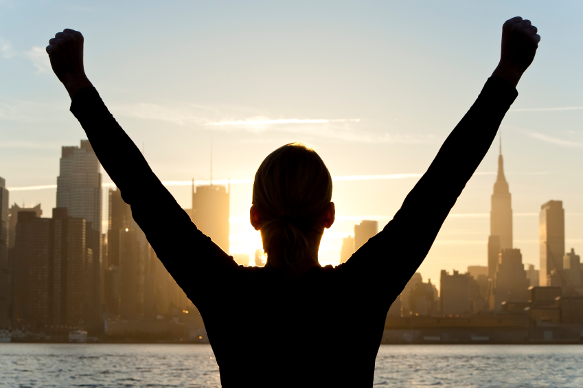Woman Celebrating Arms Raised at Sunrise in New York City