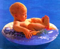 baby in float device in pool
